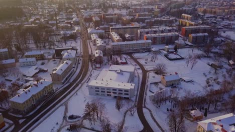 Flying-over-the-historic-city-of-Valmiera,-Latvia-during-the-wintertime