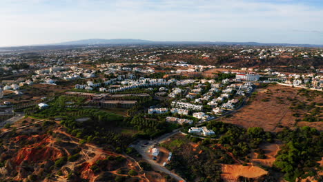 Aerial-birds-eye-shot-of-luxury-hotel-apartment-on-the-coastline-of-Algarve-in-summer