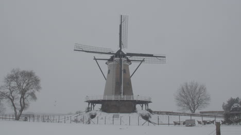 Dolly-in-of-windmill-in-snow-covered-landscape