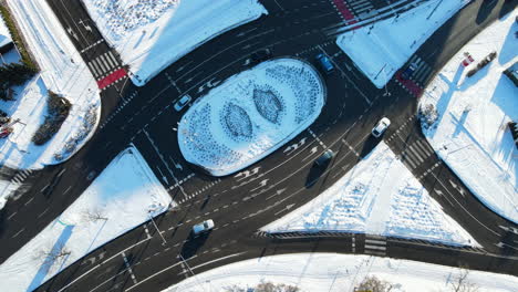Vehicles-Driving-Through-The-Roundabout-At-The-Intersection-Road-In-Gdansk,-Poland-At-Winter