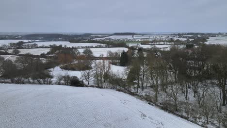 Essex,-UK-Countryside-in-winter-snowy-landscape-aerial-4k