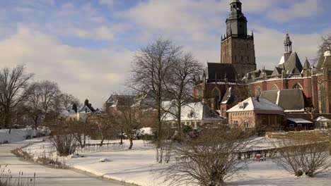 Moving-timewarp-lapse-of-historic-medieval-Hanseatic-city-Zutphen-in-winter-after-a-snowstorm-with-its-iconic-city-wall-view-and-gardens-and-river-Berkel-frozen-over