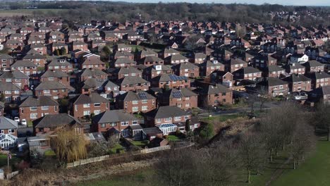 Typical-Suburban-village-residential-Essex-neighbourhood-property-rooftops-aerial-view-slow-descend-pan-right