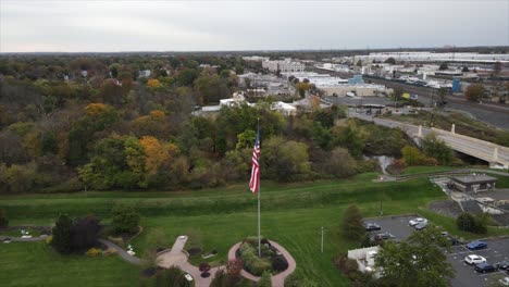 New-Brunswick-residential-drone-shot-American-flag-waving-in-air-orbital-shot