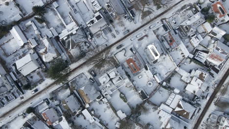 top-down-aerial-over-beautiful-snow-covered-town-in-winter