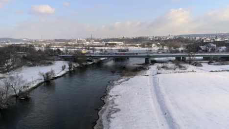 Aerial-View-of-Winter-Car-Traffic-on-Bridge-Above-Ruhr-River-by-Hattingen-City,-Germany