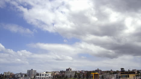 Time-Lapse:-Thick-white-and-grey-clouds-moving-across-the-sky-above-Bondi-Beach,-Sydney-Australia