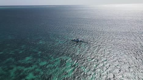 Aerial-shot-orbit-only-yacht-on-turquoise-sea-water