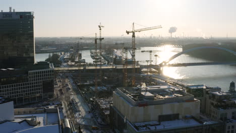 Aerial-shot-of-construction-site-development-with-lot-of-cranes-during-winter-morning-in-Slovakia-capital-city-Bratislava