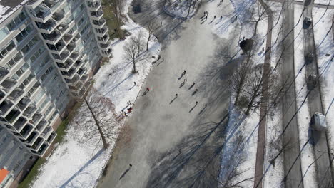 High-angle-view-of-people-skating-on-frozen-pond-in-the-Netherlands