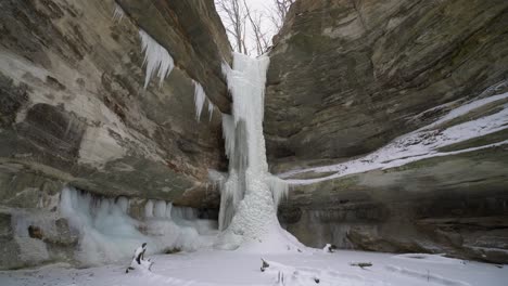 Low-angle-view-of-frozen-waterfall-in-beautiful-rocky-valley