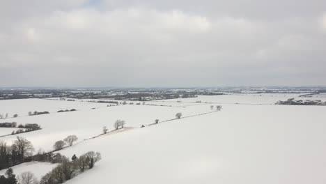 Aerial-shot-advance-forward-vast-blanket-of-white-untouched-snow-ahead