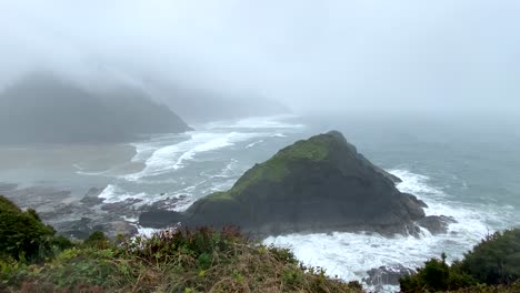Rugged-Oregon-coastline,-overcast-and-wild-Cape-Cove-bay,-handheld