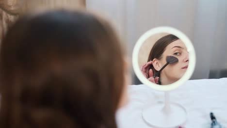 portrait-of-a-beautiful-girl-in-the-mirror-doing-makeup-herself