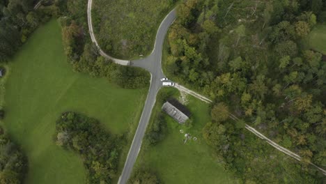 Waidischer-street-near-Freibach-reservoir-in-Austria-with-van-seen-from-the-top,-Aerial-lowering-rotating-shot