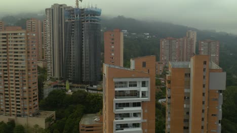 Aerial-View-of-Luxury-Medellin-Apartment-Buildings-on-Foggy-Day
