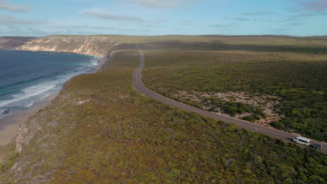 Aerial-view-of-a-camper-van-and-a-trailer,-on-the-coast-of-Kangaroo-island,-in-Australia,-sunny-day---tracking,-drone-shot