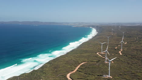 Aerial-view-of-windmills-in-a-wind-farm,-on-the-coast-of-Albany,-Australia---tracking,-Drone-shot