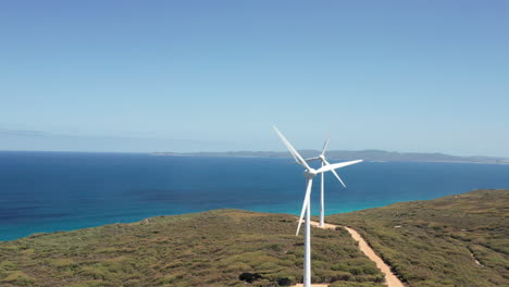 Aerial-view-around-turbines-in-a-wind-park,-on-the-shoreline-of-Albany,-Australia---orbit,-Drone-shot