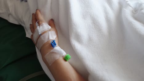 Hospitalized-woman-has-a-needle-and-tube-in-her-hand-to-easily-use-intravenous-fluids-and-medication-during-or-after-surgery