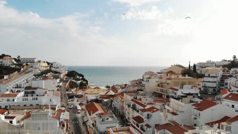 Panoramic-view-of-Carvoeiro-Town-and-white-traditional-houses-in-Lagoa,-Algarve,-Portugal---Aerial-shot