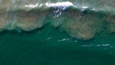 Downward-angle-drone-shot-of-ocean-waves-at-Cabarita-Beach
