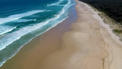 Beautiful-wide-drone-shot-of-Cabarita-beach-and-ocean-waves