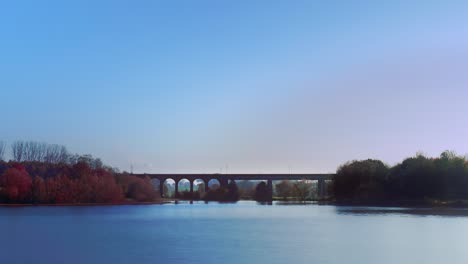 A-time-lapse-shot-of-a-lake-and-a-railway-bridge