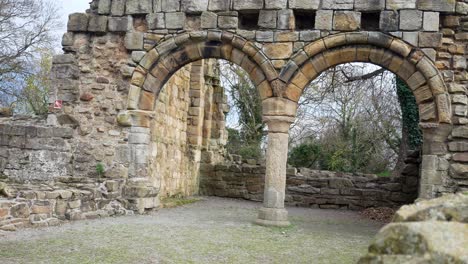 Ancient-Basingwerk-abbey-abandoned-historical-landmark-building-arched-doorway-ruins-dolly-right