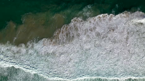 Downward-angle-drone-shot-of-ocean-waves-at-Cabarita-beach-Australia