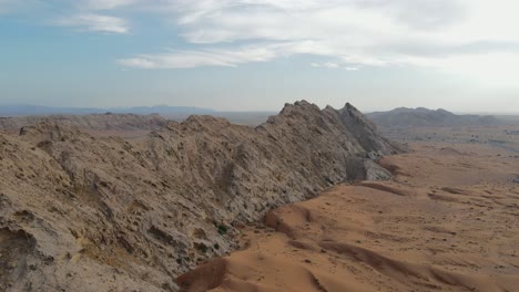 Drone-view-UAE's-Al-Faya-Mountain-range-landscape,-Sharjah's-Mleiha-desert,-Al-Faya-desert,-Hajar-mountains,-4k-winter-drone-footage