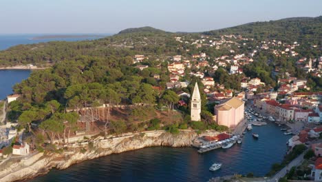 Mid-height-aerial-dolly-shot-backing-out-of-the-harbor-of-Veli-Losinj,-Croatia