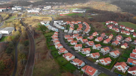 Aerial-view-above-Gothenburg-sububs-residential-area-by-railway,-day