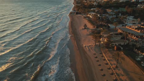 Aerial-view-of-town-coastline-during-sunset