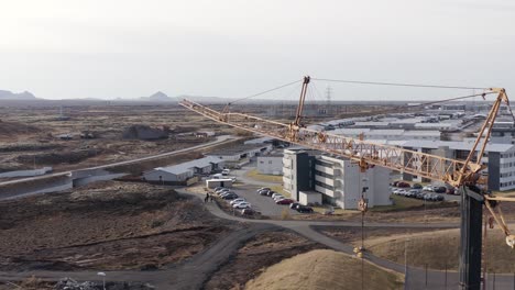 Aerial-of-construction-crane-at-development-site-on-outskirts-of-Hafnarfjordur