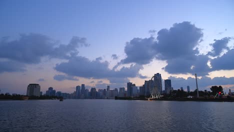 UAE-Dec-2020:-Timelapse-of-the-grey-clouds-floating-above-the-downtown-buildings-of-Khalid-Lagoon,-Sharjah,-United-Arab-Emirate