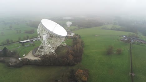Aerial-Jodrell-bank-observatory-Lovell-telescope-misty-rural-countryside-front-to-side-orbit-left