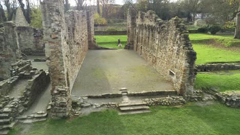 Basingwerk-abbey-landmark-medieval-abandoned-Welsh-ruins-Aerial-view-inside-pull-away