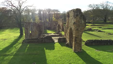 Basingwerk-abbey-landmark-medieval-abandoned-Welsh-ruins-Aerial-view-dolly-left-low-angle