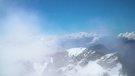 Panoramic-View-To-Snowy-Mountain-Range-From-Summit-with-Moving-Clouds
