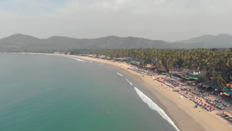 Palolem-Beach-idyllic-shoreline-and-exotic-landscape-in-Goa,-India---Aerial-Fly-over-shot