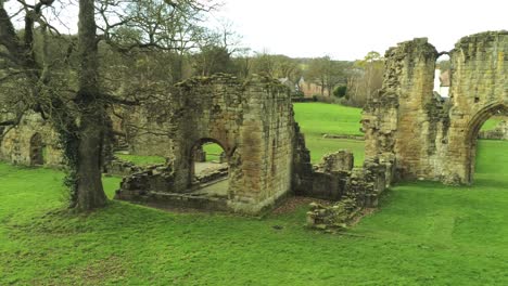 Basingwerk-abbey-landmark-medieval-abandoned-Welsh-ruins-Aerial-view-dolly-right-forwards