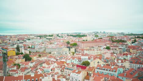 Lisbon-hill-viewpoint-through-fences-to-castle,-river-and-ancient-city-roofs