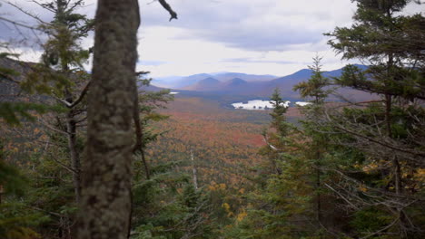 Beautiful-Autumn-View-of-the-Adirondack-Mountains-with-Vibrant-Red-and-Yellow-Colors-Filling-the-Valley-Below