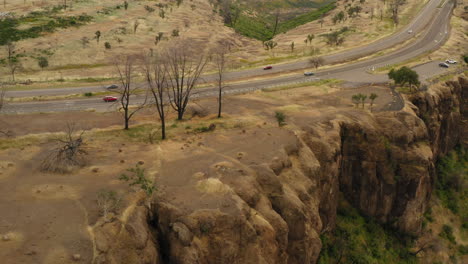 Cars-cruising-by-on-the-hiqhway-next-to-Butte-Creek-overlook,-California
