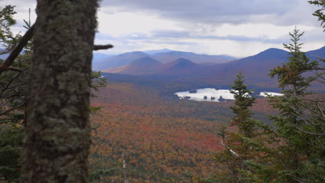 Beautiful-Autumn-View-of-the-Adirondack-Mountains-with-Vibrant-Red-and-Yellow-Colors-Filling-a-Valley