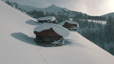 Aerial-footage-of-snowy-mountain-huts-in-the-South-Tyrolean-mountains