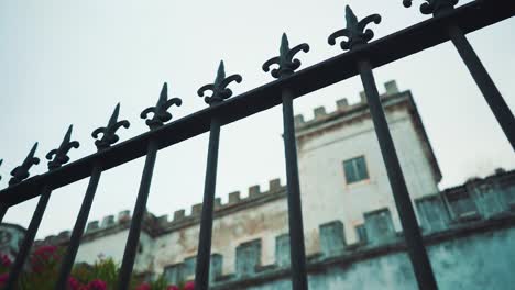Lisbon-old-castle-building-view-through-ornate-fence-railing