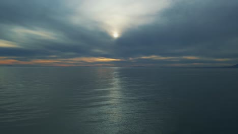 Aerial-view-over-the-sea-with-dark-clouds-on-the-horizon