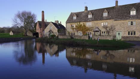 Charming-Cotswolds-village-of-Lower-Slaugher-with-its-historic-houses-and-water-mill-reflecting-in-the-River-Eye